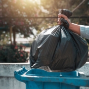 What Can Be Recycled In My Trash Man throwing away garbage in trash can