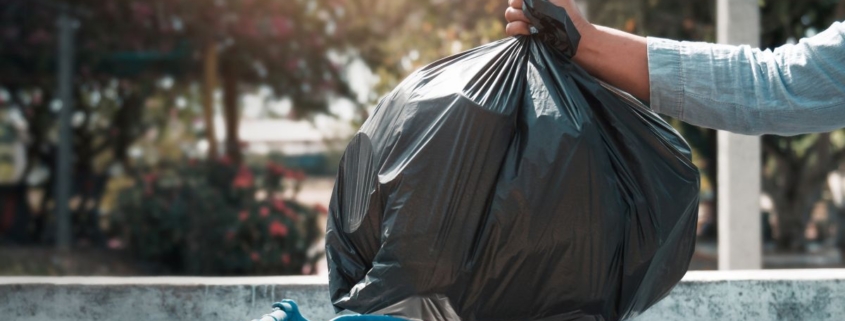 Man throwing away garbage in trash can